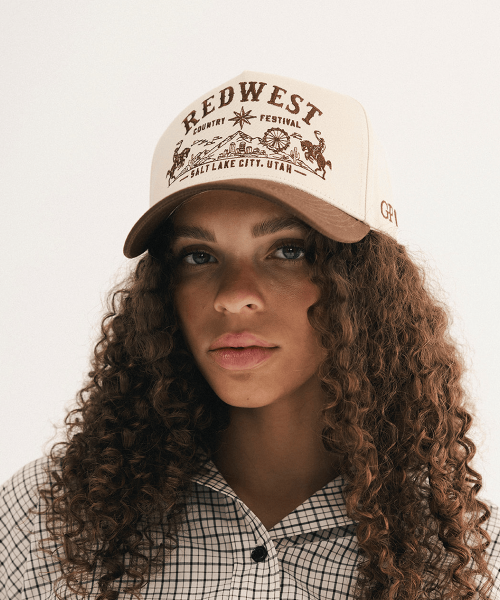 Woman wearing a brown and white baseball cap and plaid shirt in a white background #color_cream - brown
