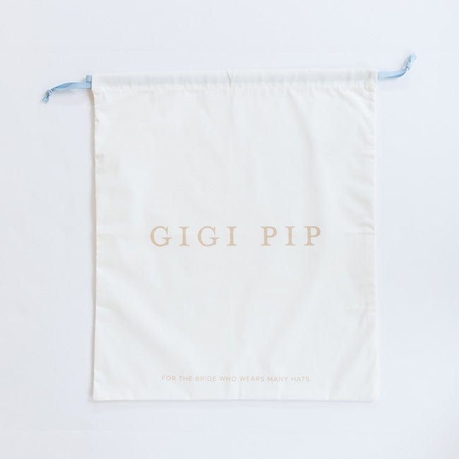A white bridal keepsake duster bag with the text 'GIGI PIP' on a plain background #color_white