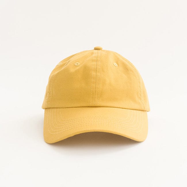 Close up image of a mustard colored ball cap on a plain background #color_mustard
