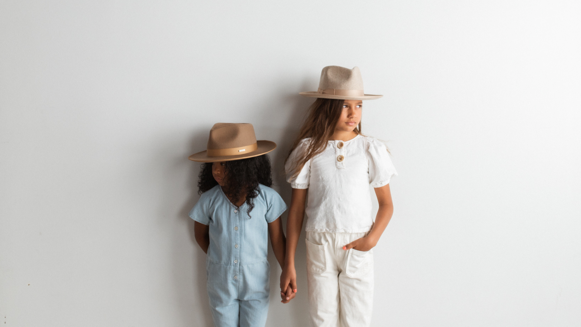 two girls wearing fashion hat