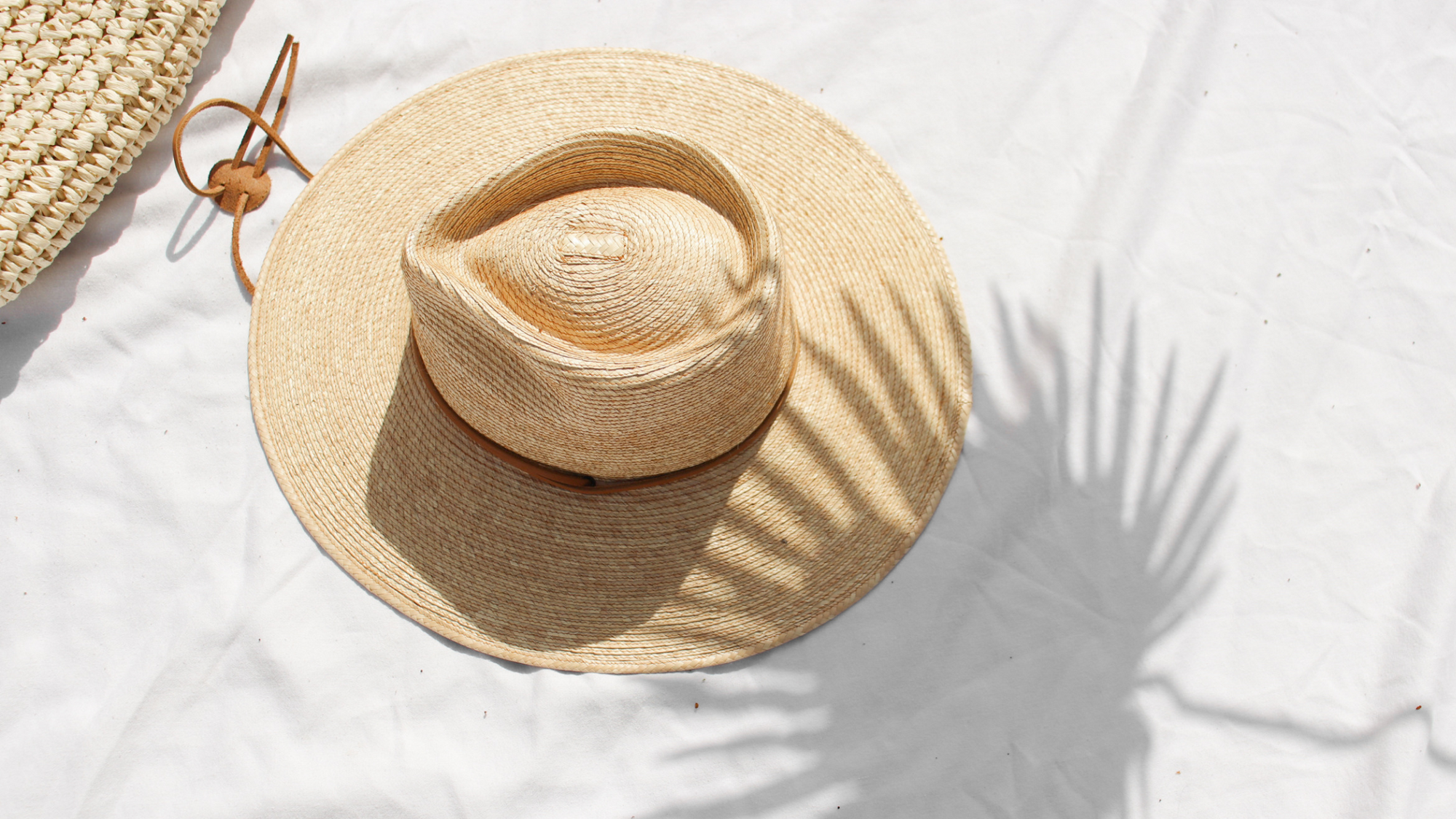 straw hat with silhouette palm leaf 