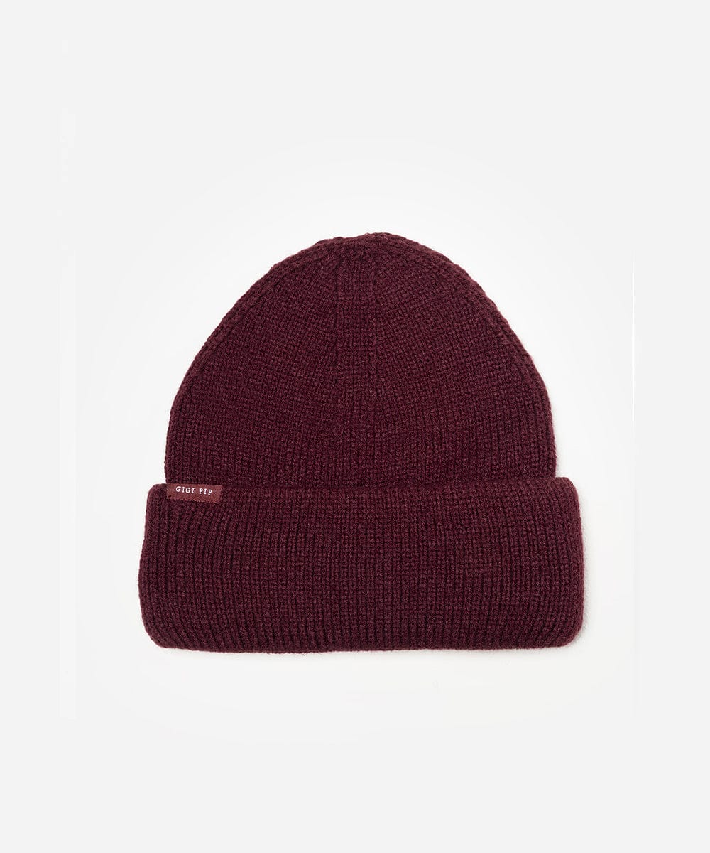 Maroon beanie with a small label on a white background #color_merlot