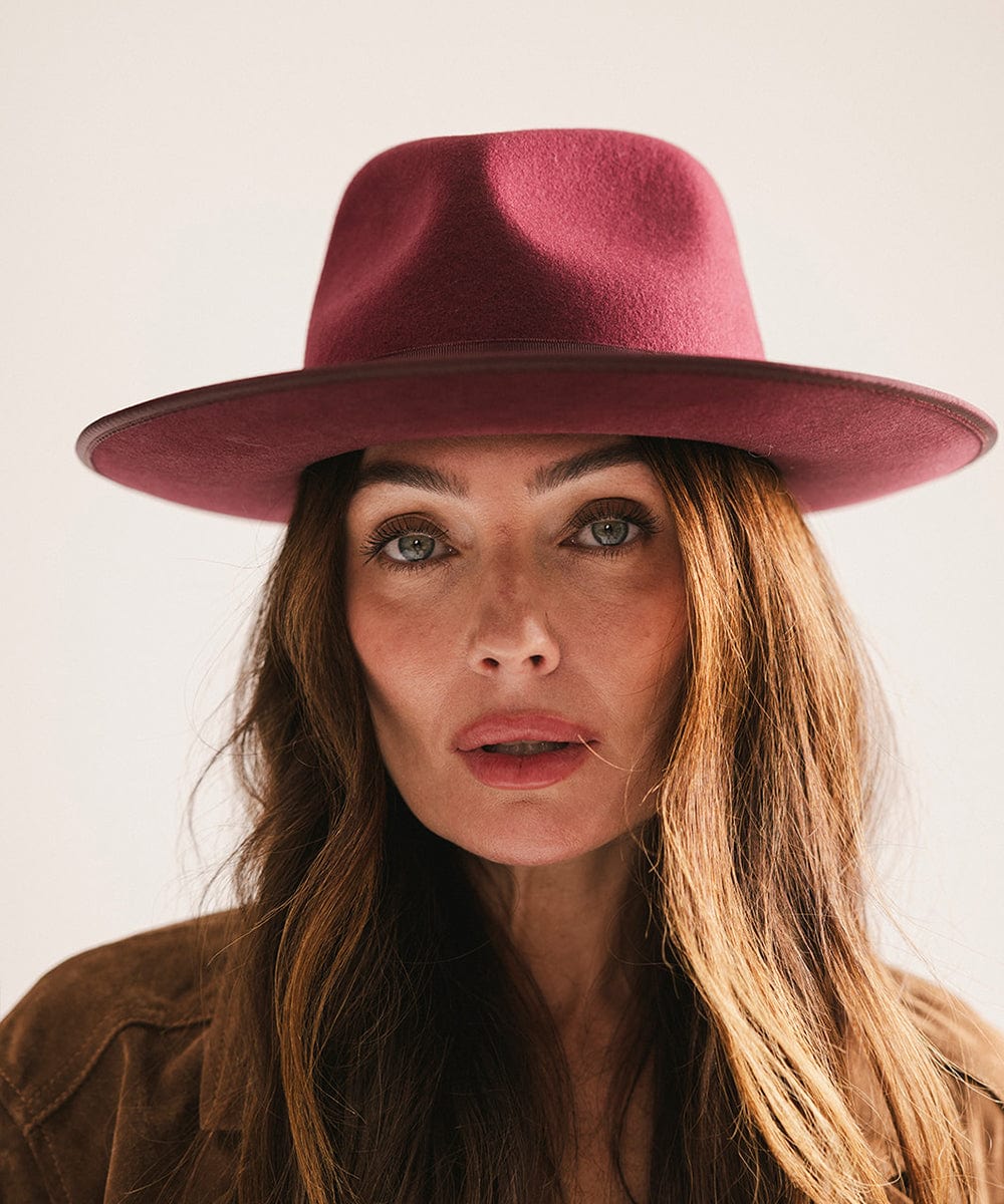 Woman wearing a merlot colored fedora hat with a band against a plain background #color_merlot