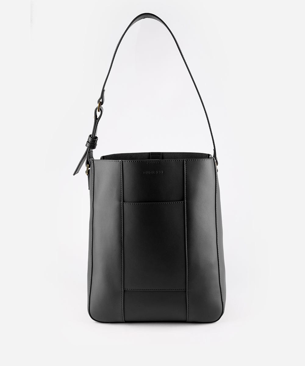 A black Dia everyday leather tote bag with an adjustable strap and a front pocket against a plain background #color_black