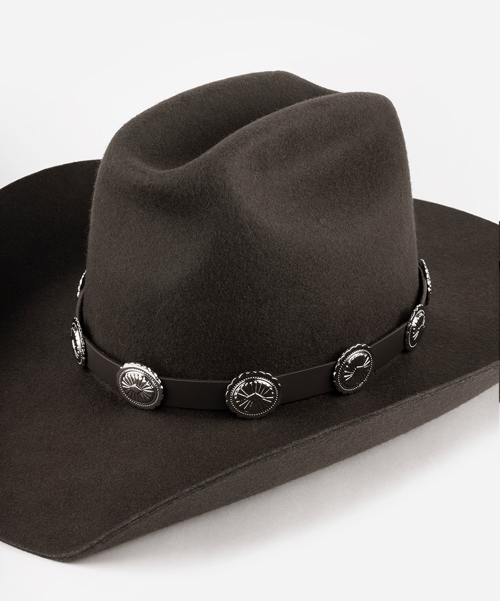 Brown cowboy hat with decorative band on a white background #color_dark brown