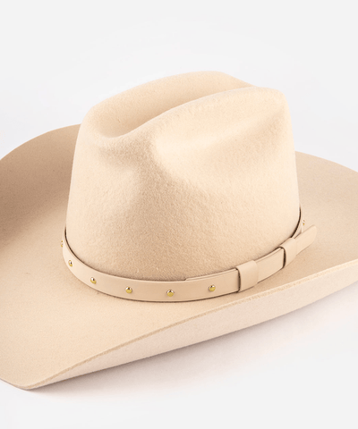 Beige cowboy hat with a band on a white background #color_cream-gold