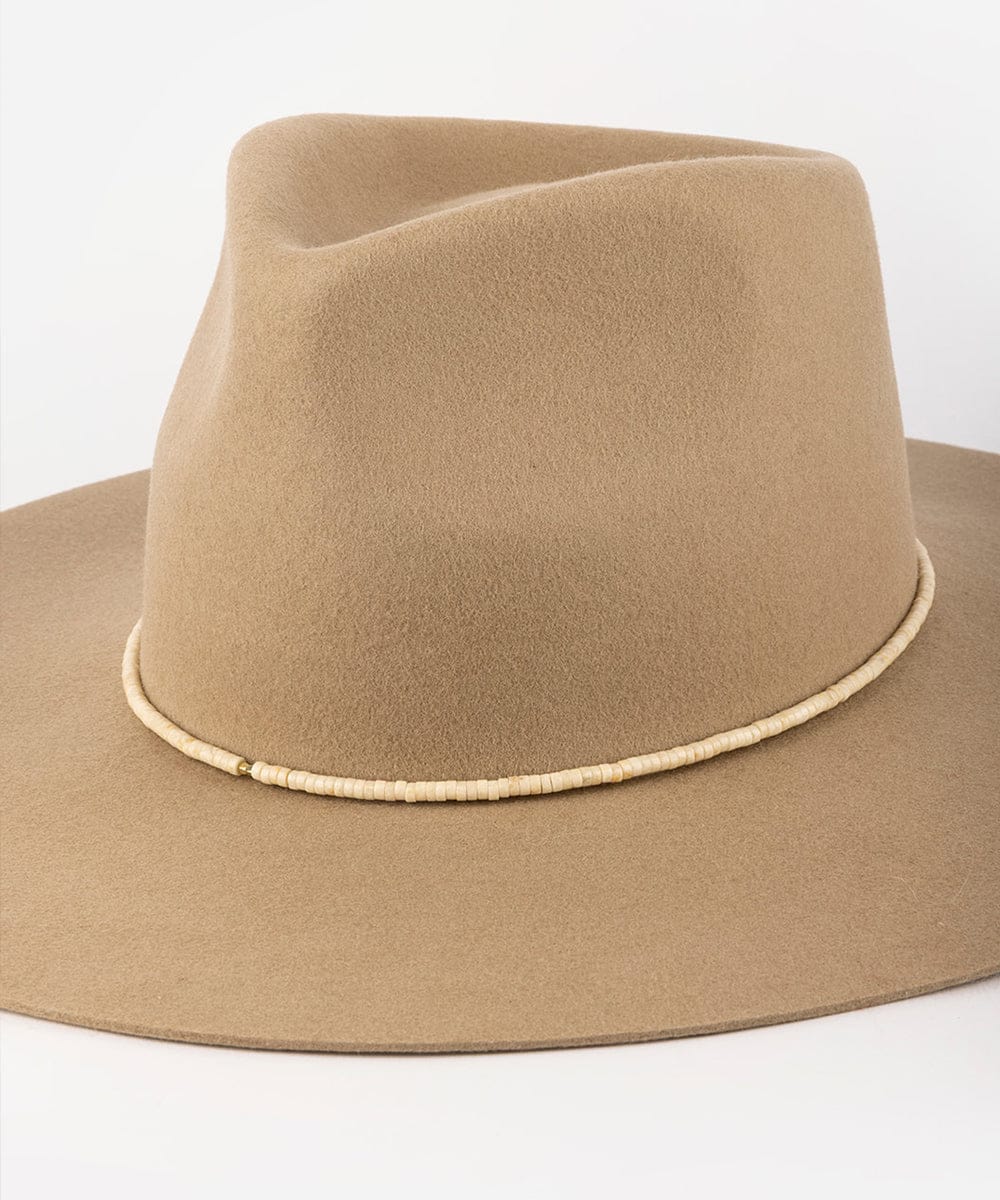 Beige fedora hat with a white band on a white background #color_natural fossil