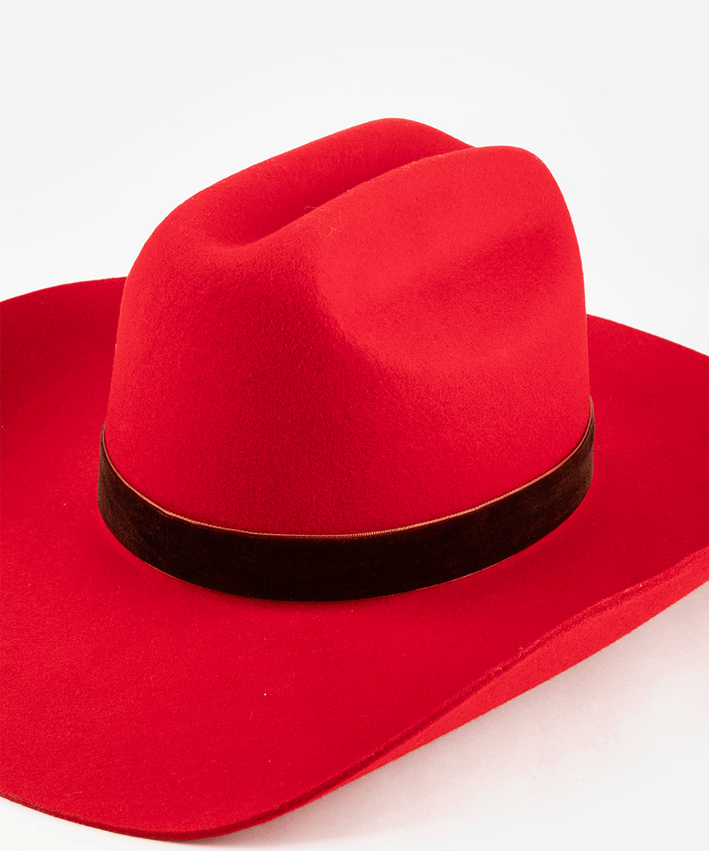 Red cowboy hat with a rusty red colored velvet chain band on a white background #color_rusty red