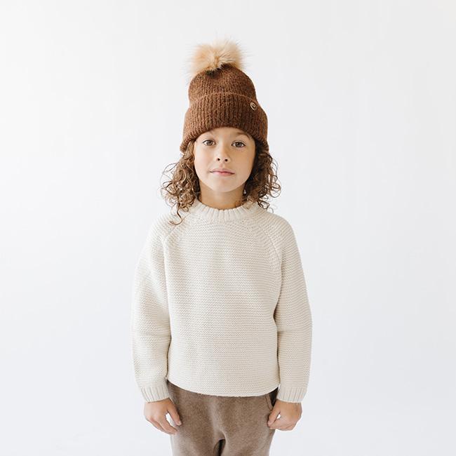 Gigi Pip beanies for kids - Milo Beanie - soft knit ribbers kid's beanie featuring a fold up brim with a rose gold Gigi Pip logo pin on the side of the fold and a pom pom on the center of the crown [camel]