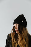 Gigi Pip beanies for women - Collins Beanie - soft knit ribbed women's beanie featuring a fold up brim with a rose gold Gigi Pip logo pin on the side of the fold [black]