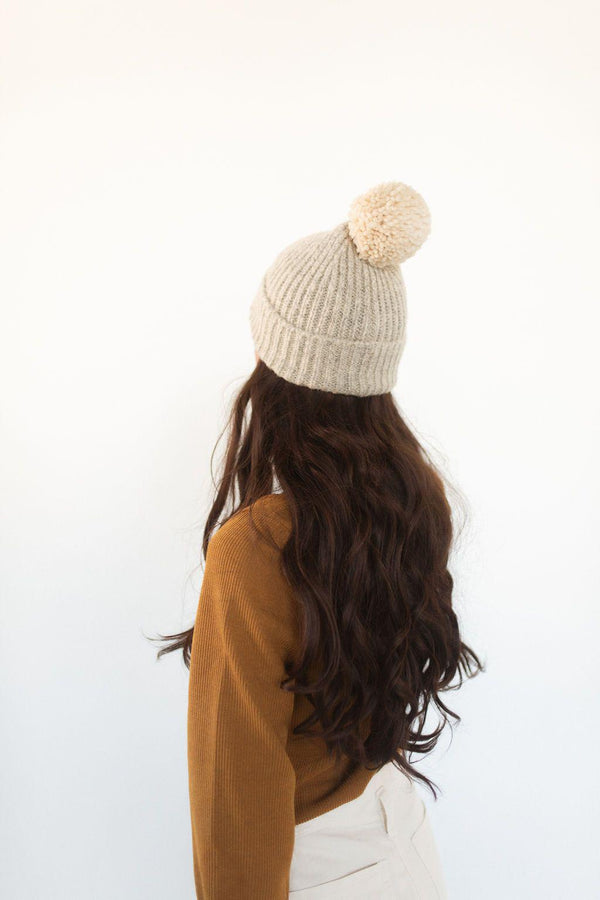 Gigi Pip beanies for women - Mo Pom Beanie - classic knit beanie with a pom on the crown, featuring the Gigi Pip logo on a metal bar on the front fold [cream]