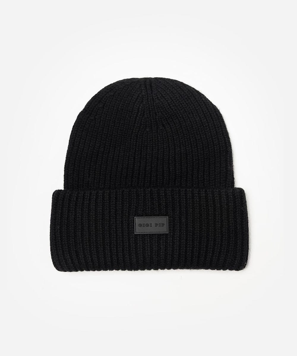 Black beanie with a label on a light gray background #color_black