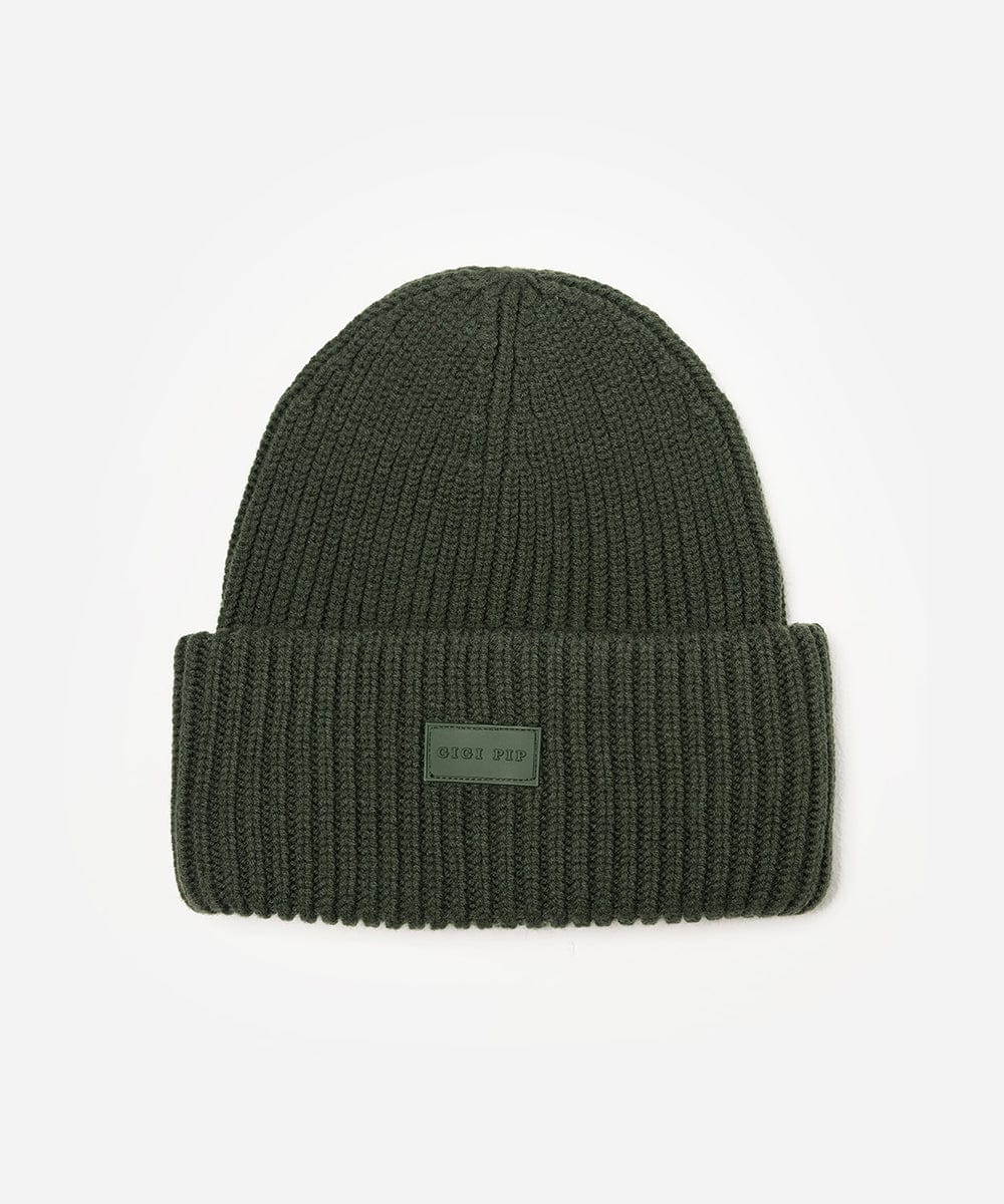 A dark green ribbed beanie on a white background #color_dark green