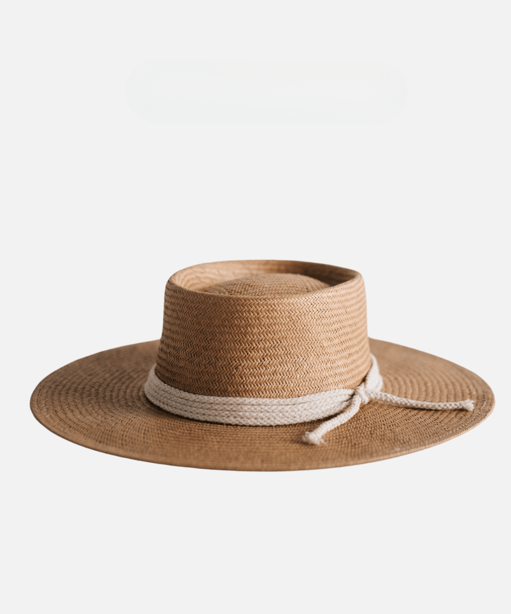 A natural colored straw hat with a white rope hat band on a plain background #color_natural