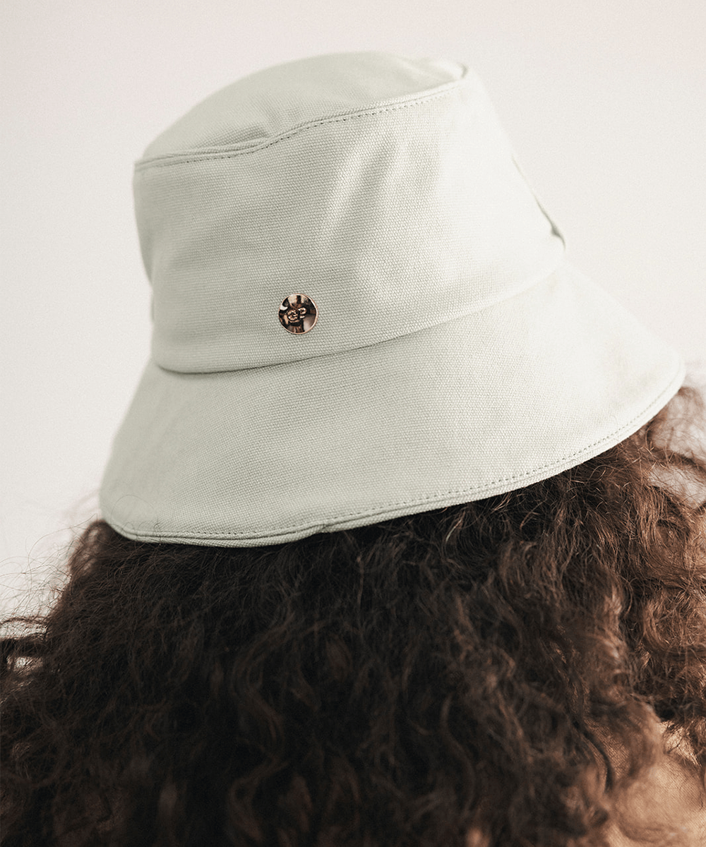 Woman wearing a sage bucket hat with a plain background #color_sage
