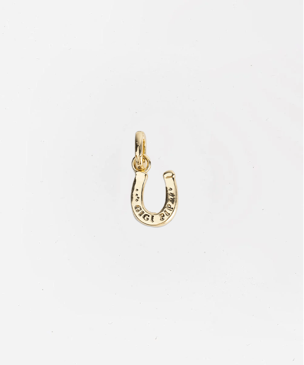 Gold horseshoe charm on a white background #color_gold