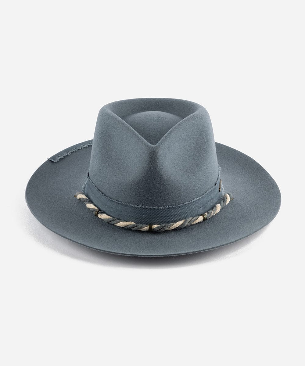 A denim colored wide brim hat with a teardrop crown and a braided chin strap on a plain background #color_denim