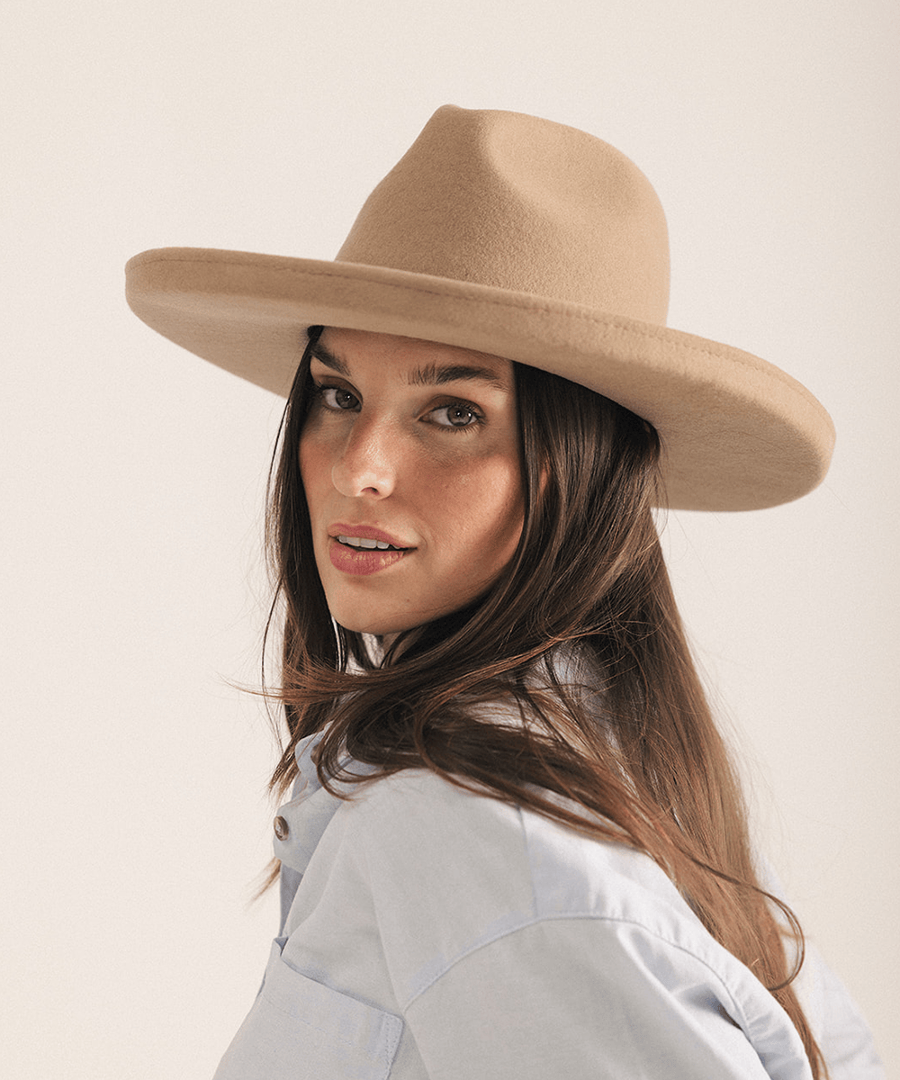Woman wearing a tan pencil brim felt fedora hat on a white background #color_tan