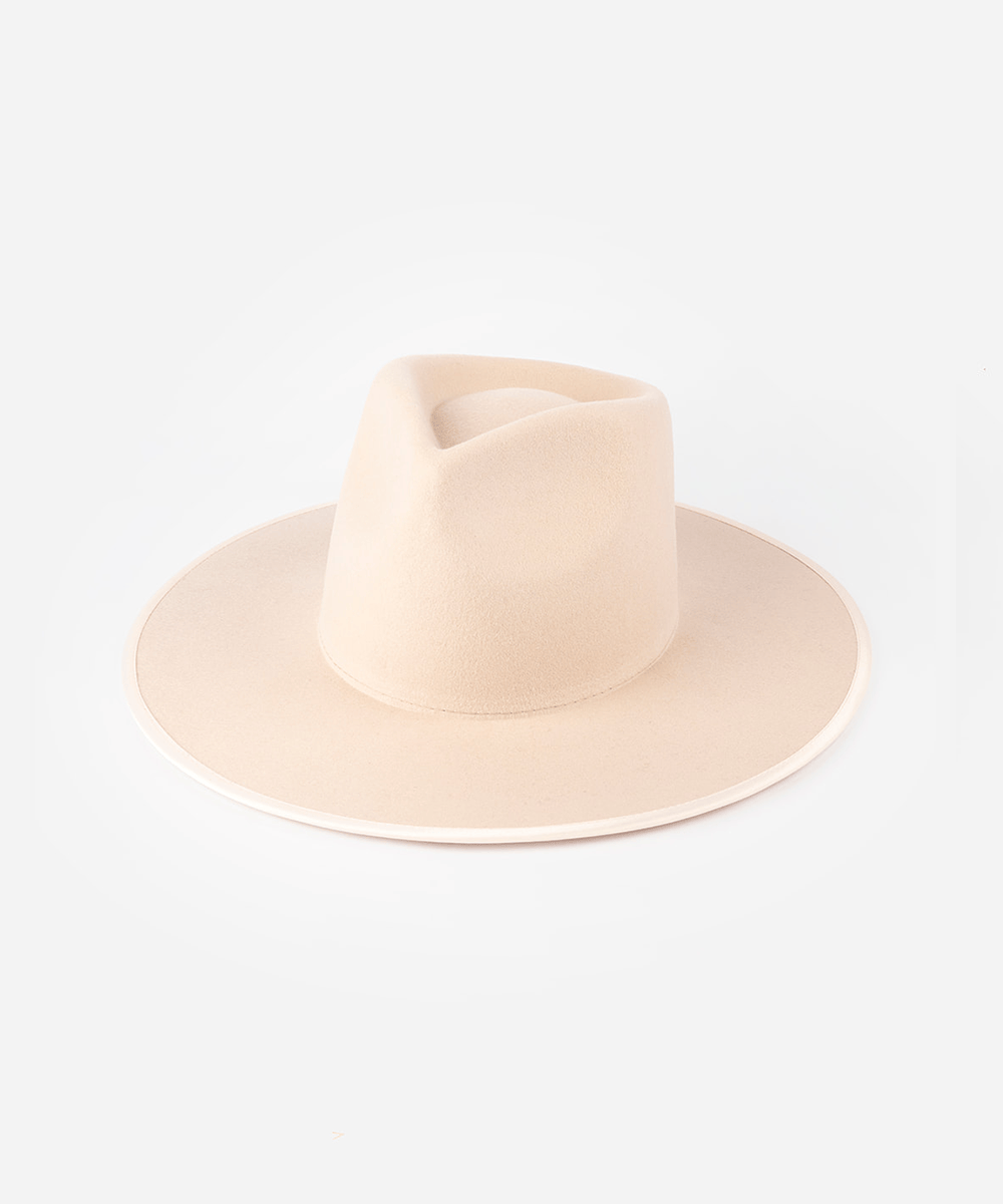 A nude colored fedora hat against a plain background #color_pale nude