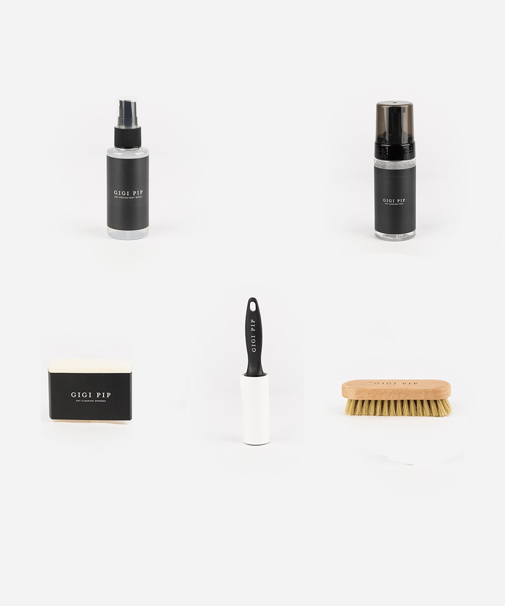 Set of cleaning products including bottles, a brush, and a cloth on a white background #color_black