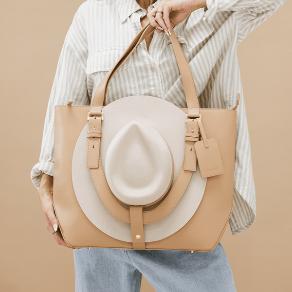 Gigi Pip luxury hat carrying totes for women - Leather Hat Carrying Tote - 100% genuine leather hat carrying tote featuring a "U" strap to cradle your hat to your bag + two interior pockets [tan]