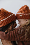 Gigi Pip beanies for kids - Kids Vail Beanie - 100% acrylic chunky knit beanie in a universal kids size featuring a comfortable plush inner band and the Gigi Pip logo on a metal bar in the front [burnt orange-cream]