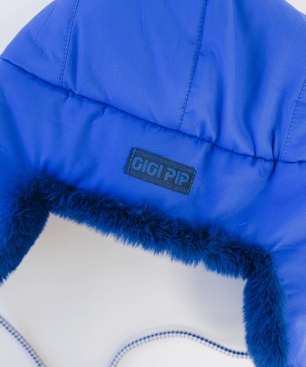 Gigi Pip winter hats for women - Leda Trapper Hat - 100% faux fur + polyester classic style inspired trapper hat featuring a retro limited edition holiday Gigi Pip logo [alpine blue]