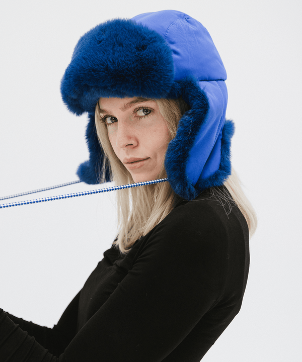 Gigi Pip winter hats for women - Leda Trapper Hat - 100% faux fur + polyester classic style inspired trapper hat featuring a retro limited edition holiday Gigi Pip logo [alpine blue]