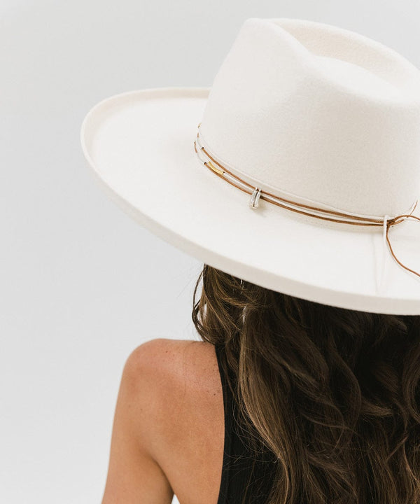Gigi Pip Limited Edition Hats for women - Limited Edition Hat 28 - 100% australian wool wide brim fedora with a pinched teardrop crown + pencol rolled brim featuring gold + silver metal bar beads on brown cords + two cowgirl boot charms [off-white]