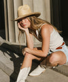 Gigi Pip limited edition hats for women - Limited Edition Hat 29 - lightweight Mexican palmilla straw Western hat with a classic Gus crown + wide curve rolled brim at the base, featuring a gold plated metal Gigi Pip pin on the back of the crown + a gold chain trim strung with 3 western style charms [natural]