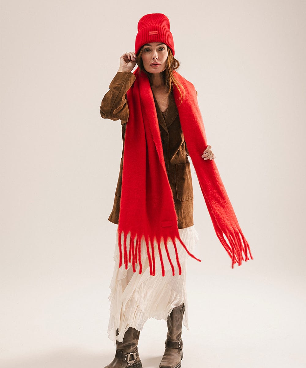 Woman wearing a red scarf and hat on a plain background #color_red
