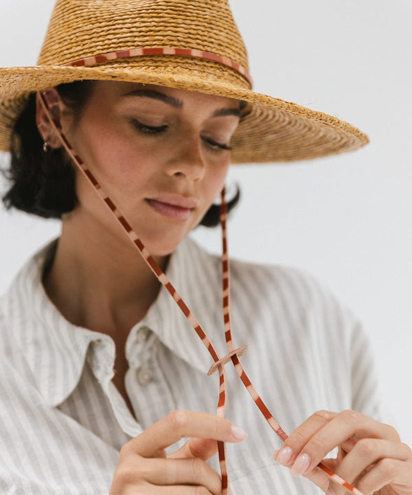 Gigi Pip straw hats for women - Ozzy Lifegaurd Hat - made of a tight weave raffia straw with a relaxed a-line brim, hand-painted leather chinstrap [honey]