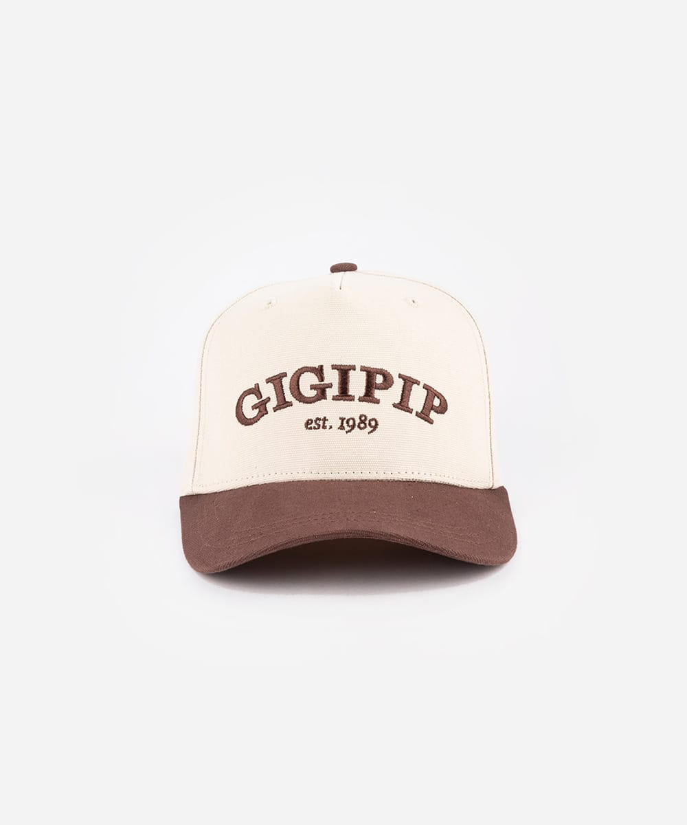 Cap with 'GIGIPIP est. 1989' text on a white background #color_cream-chocolate brown