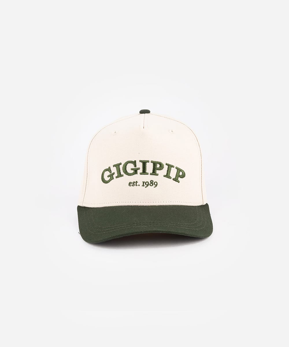 Trucker hat with 'GIGIPIP' and 'est. 1989' text on a white background #color_cream-dark green