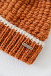 Gigi Pip beanies for women - Vail Beanie - 100% acrylic chunky knit beanie with a comfortable plush inner band, featuring the Gigi Pip logo on a metal bar in the front [burnt orange + cream]