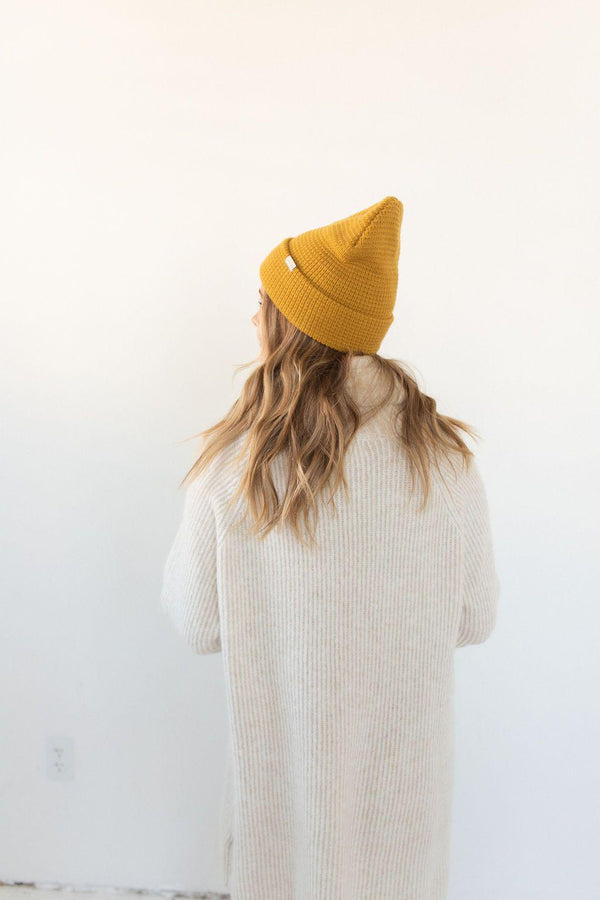 Gigi Pip beanies for women - Marsh Waffle Knit Beanie - 100% acrylic waffle knit beanie with the Gigi Pip logo on a tag over the fold [mustard]