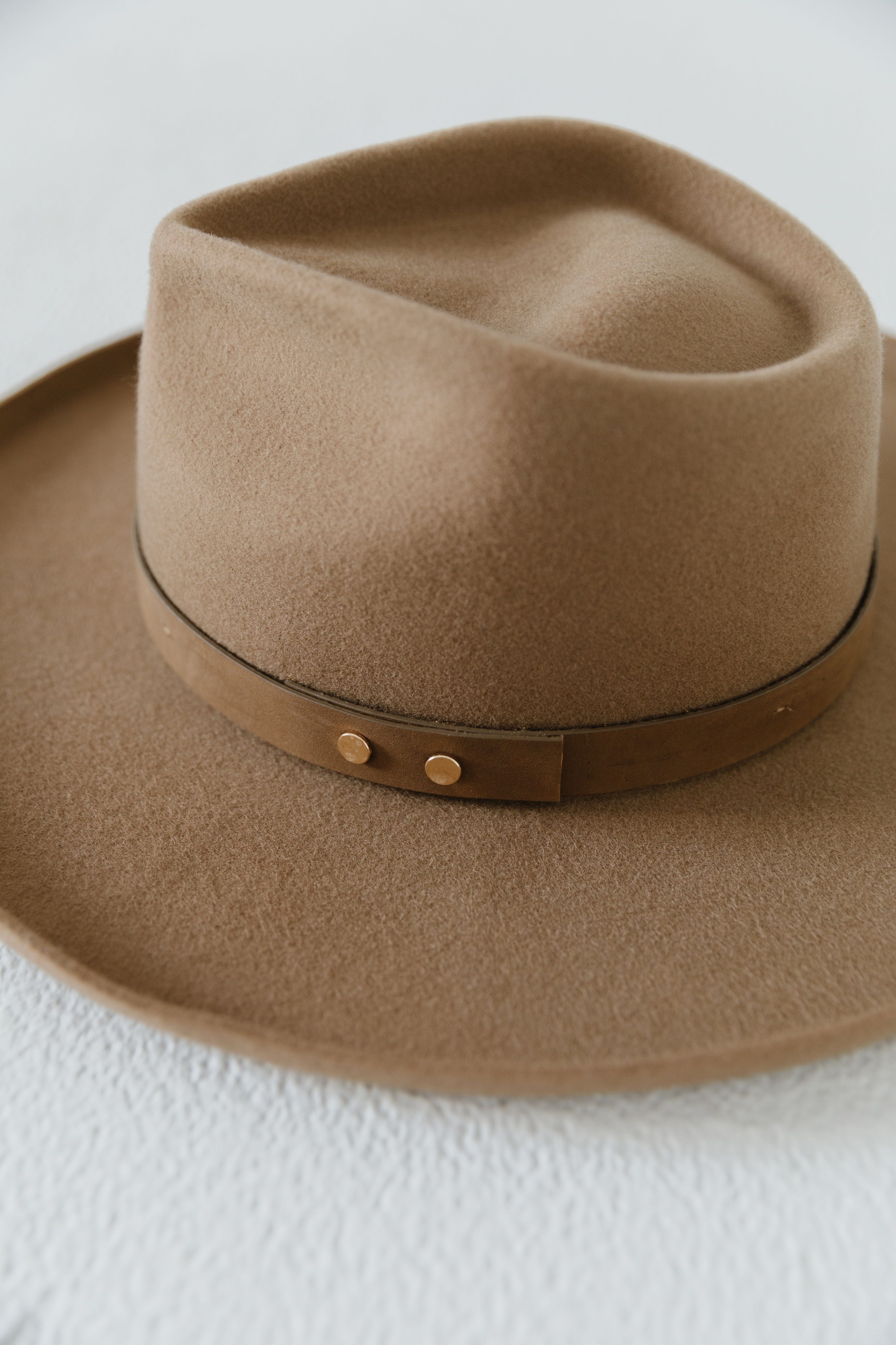 Close up image of a tan pencil brim fedora hat with a hat band on a white background #color_tan