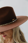 Gigi Pip felt hats for women - Raine Wide Brim Fedora - wide flat brim with a fedora crown, featuring a gold-plated removable paperclip brass chain with three faux pearls and a hand-sewn grosgrain band with the gold Gigi Pip bar around the crown, as well as a removable golden chain chinstrap [dark oak]