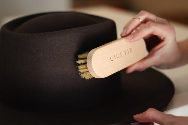 Gigi Pip hat care products - a handheld hat cleaning brush to remove dirt + lint made of wood + features the Gigi Pip name engraved on the handle [natural]